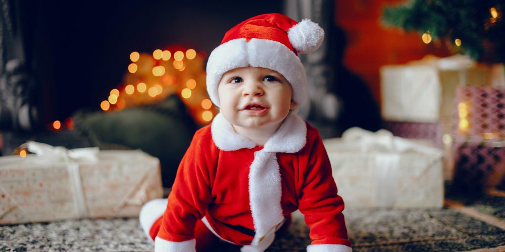 Cute little boy in a christmas costume. Child by the christmas tree